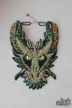 a green and black beaded dragon necklace