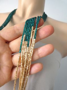 "Peacock green and light gold long boho necklace, seed bead necklace, beaded necklace, beaded multistrand necklace,green necklace,bridesmaids We can make this necklace in any colors! It has 8 strands. Matching earrings sold here https://www.etsy.com/listing/218792281/light-gold-beaded-earrings-gold Size shown in pictures is 33\". Please read specifications on SIZES below: ❤ SIZES This item comes in several sizes, kindly choose at checkout. The easiest way to find out which length suits you best Elegant Green Beaded Necklace With Tiny Beads, Elegant Green Beaded Necklaces With Gold Beads, Elegant Green Beaded Necklace With Gold Beads, Green Multi-strand Beaded Jewelry, Green Multi-strand Jewelry With Tiny Beads, Green Multi-strand Necklace With Tiny Beads, Green Tiny Multi-strand Beads, Bohemian Green Beads For Wedding, Green Beaded Necklaces With Dangling Beads For Party