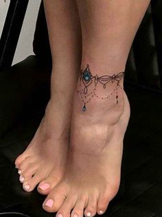 a woman's foot with a tattoo on it