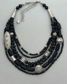 One-of-a-kind multi-strand statement necklace. Handcrafted in Scottsdale, Arizona. Beads: Matte black onyx, vintage glass, antique and sterling silver. Dimensions: approximately 21" with 2.5" extender Make a Statement with this elegant necklace. Free Shipping Refund Policy Silver Multi-strand Beaded Necklace With Black Beads, Black Bohemian Jewelry With Faceted Beads, Silver Multi-strand Necklace With Black Beads, Black Multi-strand Necklace With Silver Beads, Black Double Strand Faceted Beads Jewelry, Black Bohemian Jewelry With Polished Beads, Black Jewelry With Large Beads, Elegant Black Multi-strand Beaded Necklaces, Bohemian Black Jewelry With Large Beads