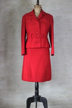 Early 1960s cherry wool skirt suit made in Italy Mod style belted jacket and pencil skirt. Jacket has two faux pockets on the breast.  Materials: Lana, Wool, Viscose Mint conditions. Size: Estimated M, about 10-12 US (see measurements) Measurements (taken with garment laying flat - double chests and waist ):   Measurements of jacket: Shoulders 42 cm - 16.5" Chest 51 cm - 20" Sleeve length 60 cm - 23.6" Back length 58 cm - 22.8" Skirt:  Waist 35 cm - 13,8" Hips 50 cm -19,7" Length 62 cm - 24.4" F Classic Winter Skirt Suit For Career, Fitted Skirt Suit With Pockets For Fall, Classic Red Skirt Suit For Work, Retro Fall Skirt Suit For Formal Occasions, Winter Career Fitted Skirt Suit, Classic Fitted Wool Skirt Suit, Fitted Vintage Outerwear With Belt Loops, Vintage Winter Skirt Suit For Work, Retro Long Sleeve Skirt Suit For Work