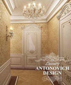 an empty room with chandelier, mirror and wall papered in gold color