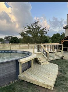 a wooden deck next to an above ground pool