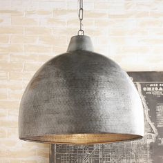 an industrial style pendant light hanging from the ceiling