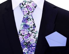 Purple, Green, and White Floret Silk Tie Picture this: you're dressing up for a special occasion, and you want to make a bold statement with your outfit. You reach for a luxurious silk necktie that catches your eye. Its luscious fabric feels silky smooth in your hands, and the intricate floral pattern in shades of purple, green, and white is mesmerizing. The playful yet sophisticated design makes you feel confident and daring. As you tie the knot of the necktie, you realize that the soft purple Floral Print Suit And Tie Accessories For Spring Business, Spring Floral Print Business Ties, Formal White Suit And Tie Accessories With Floral Print, White Floral Print Tie For Formal Occasions, Elegant Floral Print Ties For Spring, Formal White Floral Print Suit And Tie Accessories, Elegant Patterned Tie With Floral Print, Elegant Floral Print Ties For Gifts, Floral Print Ties For Spring Formal Events