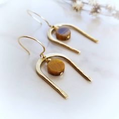 Iridescent warm brown tigers eye disc suspends from handcrafted hand forged brass. Polished & sealed with antitarnish wax to keep them bright and shiny. ~14k gold french hooks ~Wrapped and ready for gifting or keeping ~Handmade in Tennessee Modern Brown Round Jewelry, Everyday Hypoallergenic Brown Jewelry, Brown Dangle Minimalist Jewelry, Minimalist Brown Jewelry With Natural Stones, Brown Minimalist Dangle Jewelry, Brown Minimalist Drop Earrings, Minimalist Nickel-free Brown Jewelry, Minimalist Brown Dangle Jewelry, Minimalist Brown Brass Jewelry