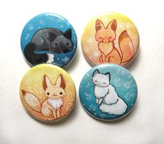 four buttons with animals on them sitting in front of a white background and the bottom one has an animal design