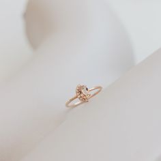 a diamond ring sitting on top of a white surface