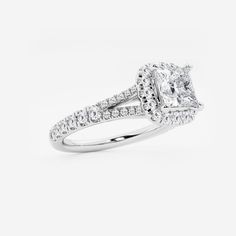 an engagement ring with a princess cut diamond in the center and pave set shoulders