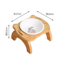 a wooden stool with a bowl on it and measurements for the height of the seat