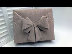 an origami box with a bow on it