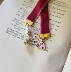 two necklaces sitting on top of an open book