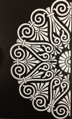 an intricately designed black and white paper with swirly designs on the inside of it