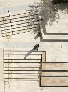 a man riding a skateboard down the side of a metal railing