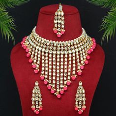 Indian Wedding Jewelry Set For your special day or that special occasion where you standout. this is the perfect necklace set! Item Specifications & Care: Dark Peach Color Kundan Necklace Set Adjustable Rope | Necklace Length: 24.00 CM x Width: 12.00 CM Earring Length: 7.00 CM x Width: 2.30 CM Maang Tikka Length: 18.00 CM x Width: 2.30 CM Metal: Alloy With Good Quality Gold Plated Color: Dark Peach | Stone: Kundan & Imitation Pearl Gross Weight: 272.00 Grams Package Content: 1 Piece Of Necklace::1 Pair Of Earring::1 Piece Of Maang Tikka Back Finding: Post with Friction Back x Earring Style: Drop Care:  Avoid exposure to heat, chemicals, perfume, alcohol, hair spray, water Avoid wearing jewelry while cooking, working out as sweat can potentially change color of jewelry Always put on your je Festive Pink Dangle Jewelry, Valentine's Day Wedding Jewelry With Matching Earrings, White Jewelry For Valentine's Day Celebration, Pink Bridal Necklace With Matching Earrings As A Gift, Silver Jewelry For Valentine's Day Festivities, Pink Wedding Necklaces With Matching Earrings, Pink Necklaces With Matching Earrings For Wedding, Pink Dangle Jewelry For Wedding, Traditional Jewelry For Valentine's Day Celebration