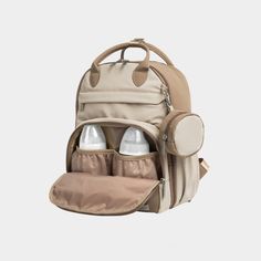 a backpack with two bottles in it and an attached diaper bag on the back