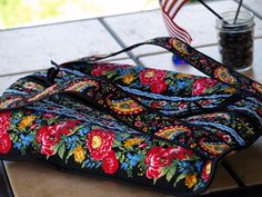 a colorful bag sitting on top of a table next to a jar with an american flag in it