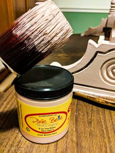 a paintbrush is being used to decorate a piece of furniture with wood shavings