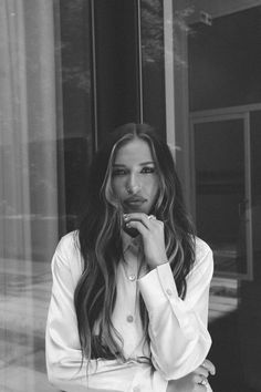 a black and white photo of a woman with long hair