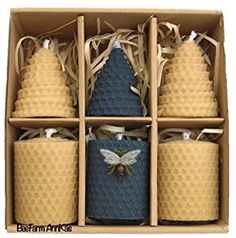 six bees in a box with blue and yellow candles