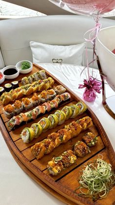 sushi platter on a boat with wine in the background