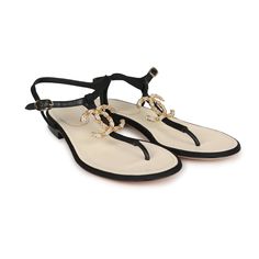 These Chanel Jeweled CC Thong Sandals are in Black Canvas with Gold Hardware. This sandal features a Gold Jeweled CC on the front of the sandal, an adjustable strap, natural leather insole, and rubber sole. Origin: ItalyCondition: New and never wornAccompanied by: Chanel box, dustbagsSize: 37 EU Designer T-strap Sandals With Removable Insole, Luxury Adjustable Open Toe Sandals, Designer T-strap Sandals With Single Toe Strap For Summer, Luxury Ankle Strap Beach Sandals, Luxury T-strap Sandals With Removable Insole, Luxury Summer Slingback Sandals With Single Toe Strap, Luxury T-strap Sandals For Summer, Luxury T-strap Sandals For Beach, Luxury Adjustable Sandals For Summer