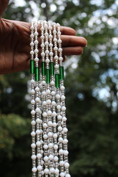 Traditional waist beads hand crafted in Ghana. Made with silver glass seed beads, and white crystal beads, w/ emerald green tube accents. Strung on cotton string with no clasp. Fits up to 45 INCHES Comes with one strand White Beaded Necklace With Faceted Beads For Festive Occasions, Festive White Beaded Chain Necklace, White Large Beads For Festive Occasions, Festive Large White Beads, Festive White Beaded Necklaces With Polished Beads, Festive White Beaded Necklace With Polished Beads, Color Meanings, Waist Beads, Cotton String