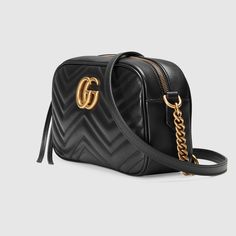 Description The small GG Marmont chain shoulder bag has a softly structured shape and a zip top closure with the Double G hardware. The chain shoulder strap has a leather shoulder detail. Made in matelassé leather with a chevron design and GG on the back. Size: 9.5″W x 5″H x 3″D / 24 x 13 x 7cm 100% genuine materials, matching the quality of the Gucci product; Black matelassé chevron leather with GG on the back Antique gold-toned hardware Double G Interior open pocket Chain shoulder strap with 2 Gg Marmont Matelassé Mini Bag, Gg Marmont Small Matelassé Shoulder Bag, Gg Marmont Small Shoulder Bag, Gucci Gifts, Gucci Gg Marmont, Black Leather Crossbody Bag, Gg Marmont, Gucci Handbags, Small Shoulder Bag