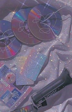 cd's and other electronic equipment on a white cloth with stars in the background