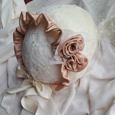 Lace christening bonnet. Cap in soft tulle base with Chantilly lace, champagne color. The interior is manufactured from soft cotton cloth. The bonnet shape at the front has a curly veil ruffle that contours its shape. On one side, the bonnet has small lace accents with two roses created and applied by hand. Ties with satin bows. DELIVERY AND RETURNS Please advise all products are ready-made, off the shelf and we offer very fast delivery with DHL. Processing time The time I need to prepare an ord Fitted White Bonnet For Baptism, White Fitted Bonnet For Baptism, Adjustable Cream Bonnet As Gift, Adjustable Cream Bonnet As A Gift, Elegant Adjustable Cream Bonnet, Adjustable Cream Bonnet For Baptism, Elegant Cream Wedding Bonnet, Lace Bonnet, Two Roses