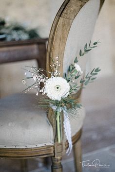 a bouquet of flowers sitting on top of a chair