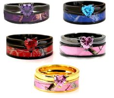 four different colored rings with hearts and flowers on them, all decorated in gold, silver, or pink