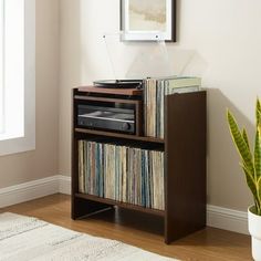 a record player is on top of a shelf