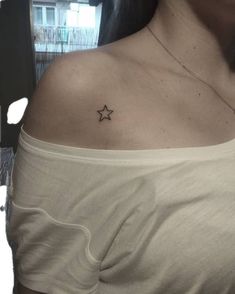 a woman with a small star tattoo on her chest