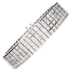 Semi-rigid bracelet with 204 princess cut diamonds total weight about 20.00 ct. The bracelet is made up of 4 rows of princess cut diamonds, each diamond is set between two white gold rails. The bracelet has a retractable closure and also an additional safety closure in the part below the bracelet. The bracelet is in 18 kt white gold and is handmade. •Diamond Cuts: Princesse •Total Number of Diamonds: N° 204 •Total Caratura Diamonds: Ct 20.00 (Approximately) •Weight Grams: gr 50 •Bracelet Length: Rectangular Diamond Cut Bracelet For Wedding, Rectangular Diamond Cut Wedding Bracelet, Rectangular Diamond Bracelet With Jubilee Design, Formal Princess Cut Diamond Bracelet, Rectangular Diamond Cut Wedding Bracelets, Princess Cut Diamond Bracelet For Wedding, Formal Cubic Zirconia Princess Cut Bracelets, Formal Princess Cut Cubic Zirconia Bracelets, Luxury Princess Cut Bracelets For Weddings