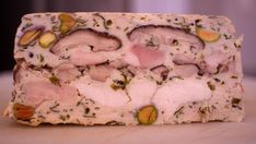 a bar of soap with nuts and herbs on it