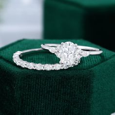 a diamond ring sitting on top of a green box