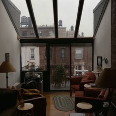 a living room filled with furniture and windows