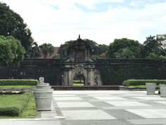 a large white and black checkerboard pattern in the middle of a park area