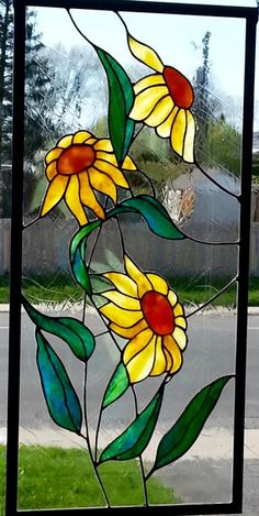 a stained glass window with sunflowers on it