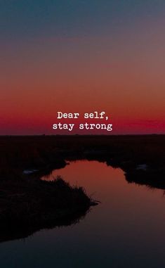 the words dear self, stay strong are displayed in front of an orange and blue sunset