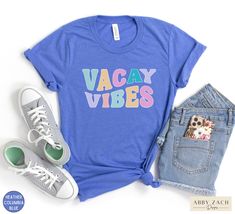 Vacay Vibes headed your way! This vacation shirt is printed soft and comfy Bella and Canvas brand tshirts. Let the adventure begin! More vacation shirts at our homepage. https://www.etsy.com/shop/AbbyZachDesigns ----HOW OUR SHIRTS ARE MADE ----  * We use the process of DTG, which stands for direct to garment printing. We partner with a professional printer who applies ink directly into the shirt. (We do not use vinyl.) This gives you better quality and will not peel. ----PRODUCT INFORMATION ---- Casual Text Print Tops For Weekend, Casual Weekend Tops With Text Print, Trendy Letter Print Shirt For Vacation, Blue Graphic Print Shirt For Vacation, Trendy Vacation Shirt With Letter Print, Casual Tops For Leisure And Vacation, Casual Tops For Leisure Vacation, Casual Vacation Tops For Leisure, Casual Graphic Print Shirt For Vacation