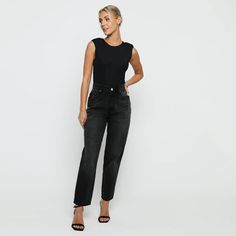 "Add some edge to your wardrobe with our black wash elasticated waist mom jeans. With a high waisted and straight leg fit, they'll make you look bold and more flattering. Made from soft denim fabric, they're also adjustable at the waist for a perfect fit. So go ahead and pair this beauty with cute tops and rock street style with confidence! Few amazing attributes: Black wash Denim fabric Straight hem High waisted Regular fitting Button and zip fly fastening Belt loops 5-pocket design Internal waist adjusters as product image Fabric: 100% Cotton Note: This Model is 5'9\" and Wears Size 8, To find the perfect fit for yourself check our Size Guide.   WOMEN'S HIGH WAISTED MOM JEANS Size = 6 - 18 Waist = 66cm - 90cm Hip = 98cm - 122cm Inside Leg = 77cm Waist is measured from All Around. Hip is Black High Rise Cropped Jeans For Work, Black High-rise Cropped Jeans For Work, Black Straight Leg Cropped Jeans For Work, Black Cropped Straight Leg Jeans For Work, Trendy Black Straight Jeans, Black High-waisted Jeans, Black Straight Leg Jeans For Work, Black Tapered Leg Cropped Jeans, Black Relaxed Fit Cropped Jeans With Tapered Leg