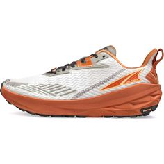 a white and orange running shoe with an orange sole on the bottom, side view