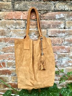 Suede shopper bag. Large tote leather bag in saddle brown.  Camel brown carry all bag made with natural genuine suede  leather. This  comfortable boho bag in tan color is  large enough to fit most laptops, tablets, books etc.  This laptop or book bag is  NOT LINED.  We added  a small leather zipper pouch for your mobile phone and/or cards or money.  It ist attached to the inside of the bag by a metal chain.   HARDWARE IN SILVER - CLOSED WITH A MAGNETIC SNAP Measurements with the bag laid flat Wi Suede Hobo Tote Bag For Everyday Use, Suede Tote Satchel With Soft Leather, Suede Satchel Tote In Soft Leather, Everyday Suede Hobo Tote Bag, Soft Suede Leather Tote Satchel, Rectangular Suede Bag For Fall, Everyday Suede Tote Shoulder Bag, Soft Suede Leather Satchel Tote, Everyday Suede Bags For Fall