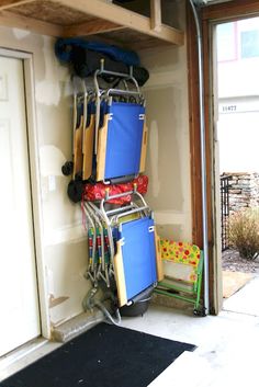 there is a rack full of luggage in the garage