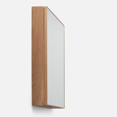 a wooden and glass cabinet against a white background with the reflection of it's door