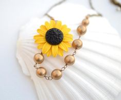 Golden Yellow Sunflower and Antique Gold Beads Asymmetrical Necklace. FREE EARRINGS Gold Flower Beaded Chain Jewelry, Gold Flower Shaped Beaded Chain Jewelry, Gold Beaded Chain Flower Jewelry, Gold Flower-shaped Beaded Chain Jewelry, Gold Flower-shaped Jewelry With Gold Beads, Gold Flower Jewelry With Gold Beads, Gold Floral Jewelry With Gold Beads, Clay Sunflower, Asymmetrical Necklace