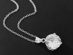 Clear Cubic Zirconia Single Silver Wedding Bridal Pendant Necklace with .925 Sterling Silver Chain. PLEASE READ ITEM DESCRIPTION and SHOP POLICIES before placing your order, and contact me with any questions! CHAIN is 18.00 inches (45.7cm) long. PENDANT is about 0.70 inch (1.8cm) long including bail. BRIDAL NECKLACES SECTION: https://www.etsy.com/shop/LanaChayka?ref=seller-platform-mcnav§ion_id=11638944 BRIDAL EARRINGS SECTION: https://www.etsy.com/shop/LanaChayka?ref=seller-platform-mcnav&secti Solitaire Diamond Pendant Necklace For Wedding, Wedding Solitaire Diamond Pendant Necklace, Vvs Clarity Round Pendant Diamond Necklace For Wedding, Round Cubic Zirconia Bridal Necklace With Prong Setting, Wedding Diamond Necklace With Vvs Clarity And Round Pendant, Dazzling Solitaire Necklace With Vvs Clarity For Wedding, Wedding Bridal Necklace With Vvs Clarity Round Cut, Dazzling Wedding Necklace With Vvs Clarity, Dazzling Vvs Clarity Solitaire Necklace For Wedding