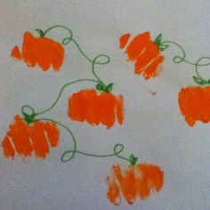 some orange flowers are drawn on a white paper with green stems in the shape of pumpkins